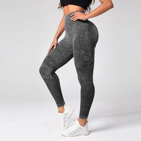 Leggings athlétiques gris à taille haute avec des motifs texturés sur les jambes.