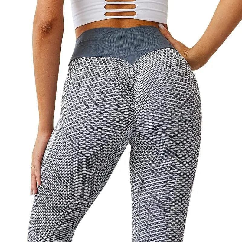 Leggings gris texturés avec un motif en forme de nid d’abeille, portés sur le bas du corps.